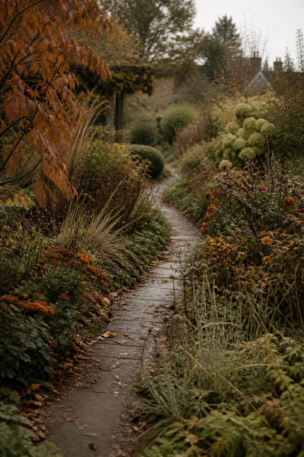 A winding path through an autumn cottage garden